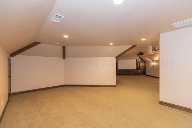 bonus room featuring light carpet, ceiling fan, and vaulted ceiling