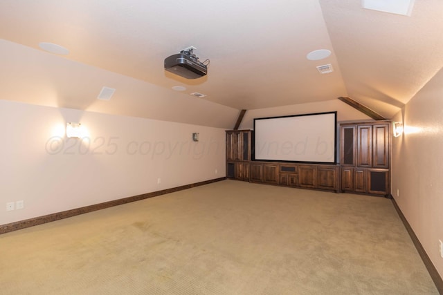 home theater room with light colored carpet and lofted ceiling