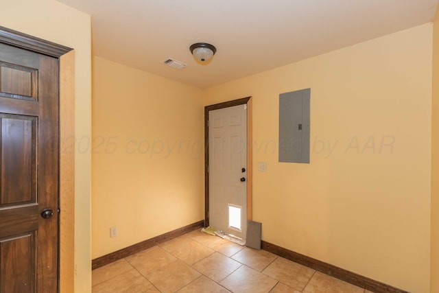 spare room with light tile patterned floors and electric panel