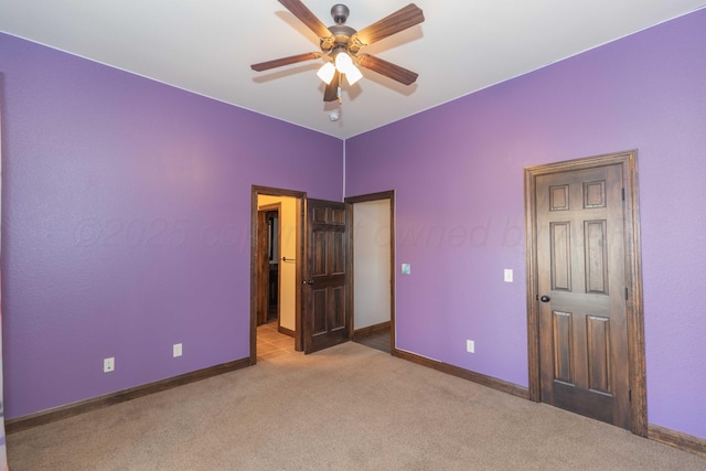 unfurnished bedroom featuring ceiling fan and light colored carpet