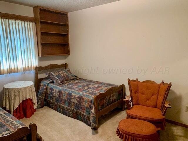 carpeted bedroom with a textured ceiling