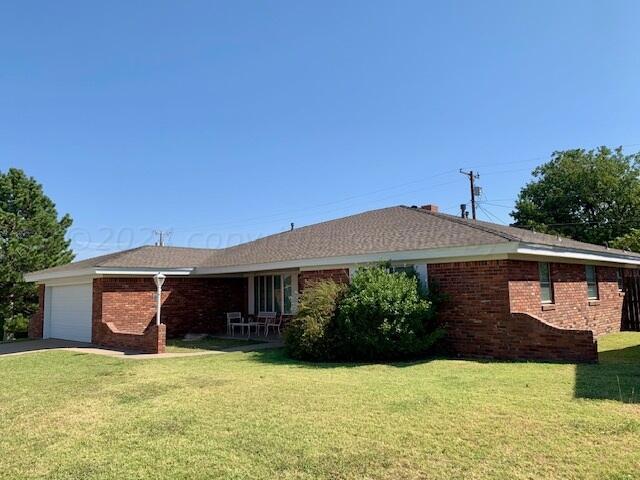 single story home with a garage and a front yard