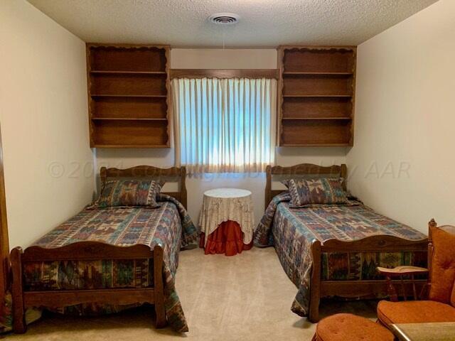 carpeted bedroom featuring a textured ceiling