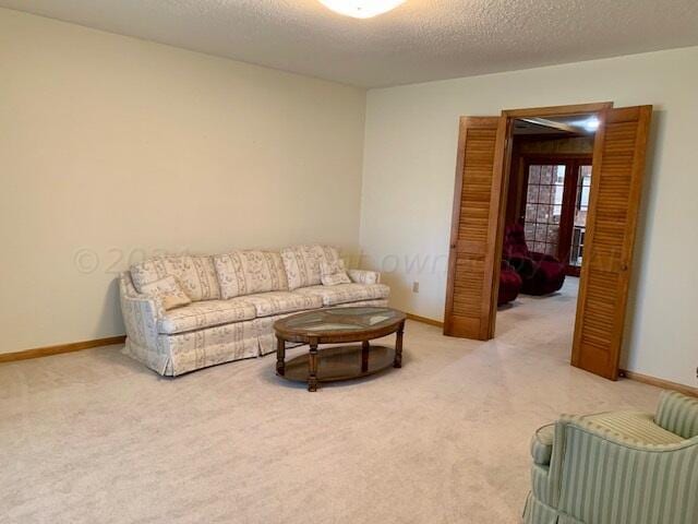 living room featuring carpet floors and a textured ceiling