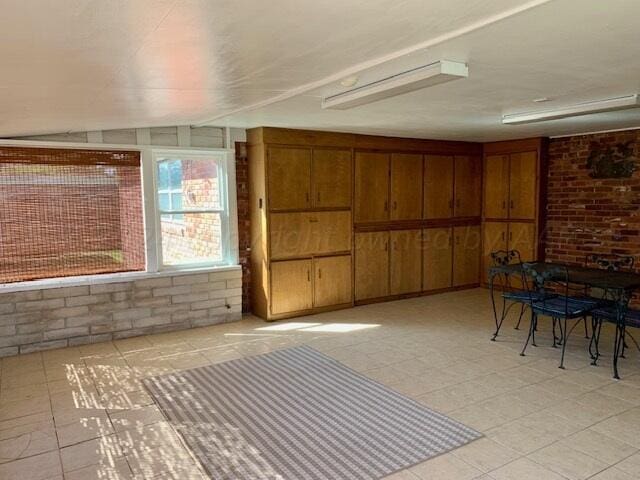 interior space with wooden walls and brick wall