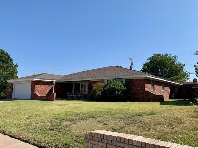 ranch-style house with a front lawn and a garage