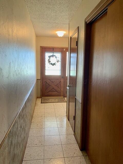 doorway featuring a textured ceiling