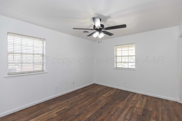 unfurnished room featuring dark wood-type flooring, baseboards, and a ceiling fan