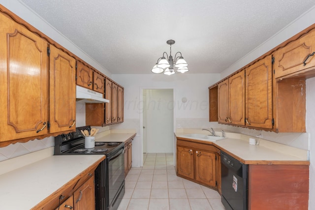 kitchen with black appliances, under cabinet range hood, a sink, a chandelier, and brown cabinets