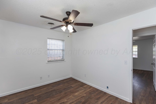 unfurnished room with dark wood finished floors, ceiling fan, and baseboards