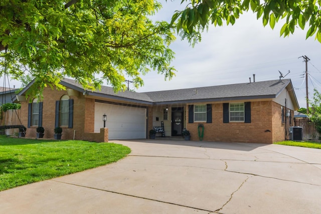 ranch-style house with brick siding, driveway, a garage, and cooling unit