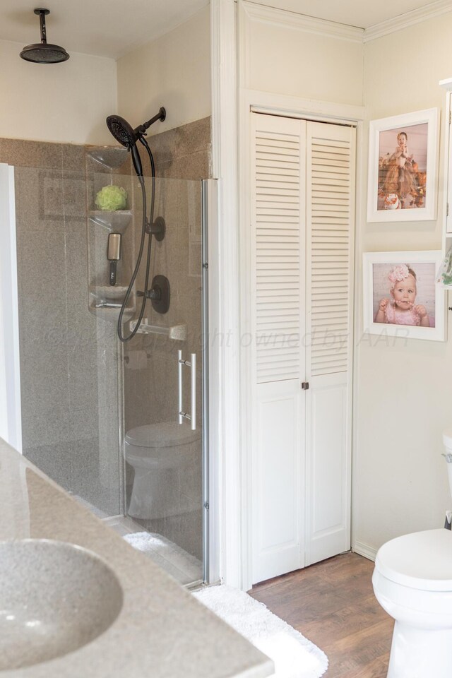 1002 S Main St, Wheeler, TX 79096 - bathroom with a closet, a shower stall, wood finished floors, crown molding, and vanity