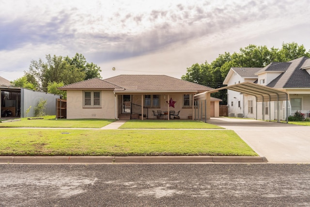 1002 S Main St, Wheeler, TX 79096 - view of front of home with a porch, driveway, a carport, and stucco siding