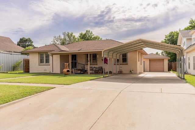 1002 S Main St, Wheeler, TX 79096 - single story home with a detached carport, a porch, driveway, stucco siding, and a garage