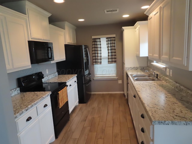 7208 Gemini Trl, Amarillo, TX 79118 - kitchen featuring black appliances, a sink, white cabinetry, and recessed lighting