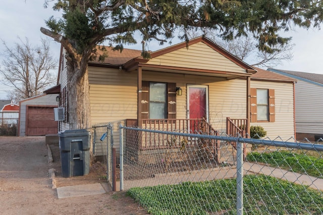 view of front of property featuring a garage and an outbuilding