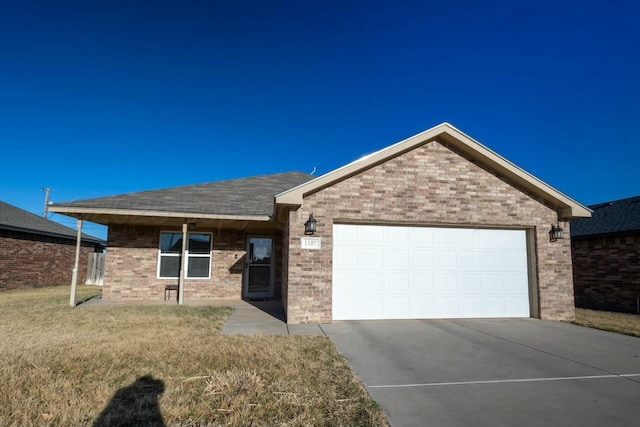 ranch-style home with concrete driveway, an attached garage, brick siding, and a front yard