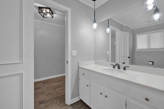3700 Paramount Blvd, Amarillo, TX 79109 - bathroom with vanity, ornamental molding, and wood finished floors