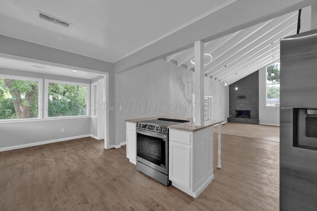 3700 Paramount Blvd, Amarillo, TX 79109 - kitchen featuring stainless steel appliances, open floor plan, a fireplace, light wood-type flooring, and white cabinets