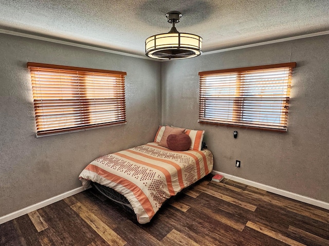 bedroom with crown molding, dark hardwood / wood-style flooring, and a textured ceiling