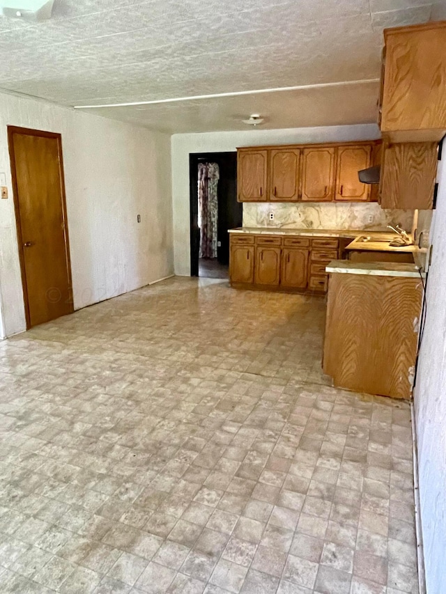 kitchen featuring tasteful backsplash and sink