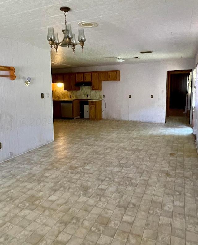 unfurnished living room with a chandelier