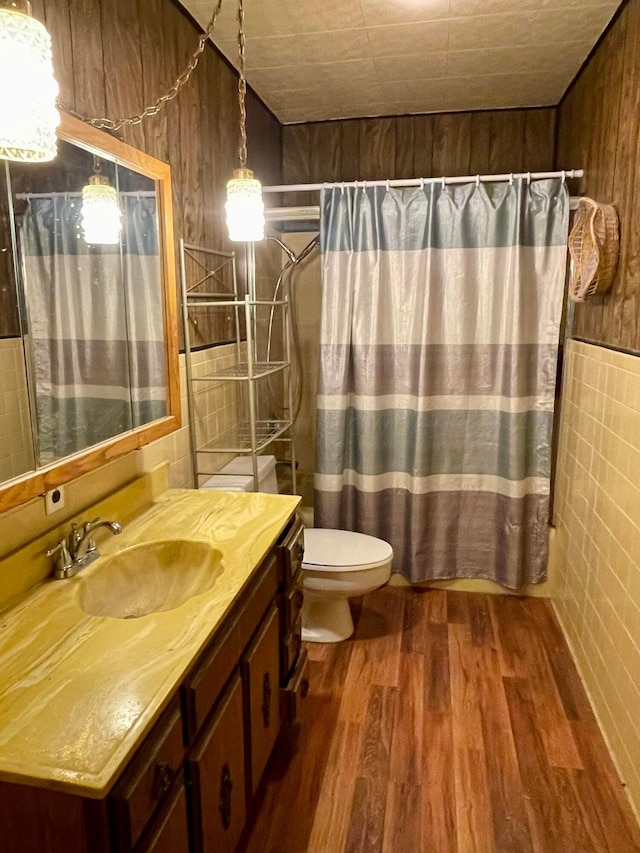 bathroom featuring vanity, hardwood / wood-style flooring, toilet, and walk in shower