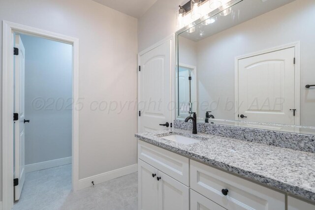 719 Prairie Ave, Dumas, TX 79029 - bathroom featuring baseboards and vanity