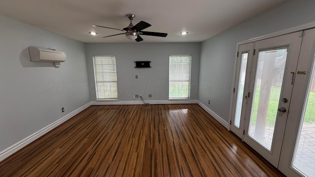 1011 S Lamar St, Amarillo, TX 79102 - spare room featuring an AC wall unit, dark wood-style flooring, ceiling fan, and recessed lighting