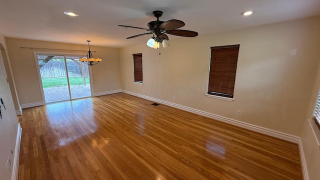 1011 S Lamar St, Amarillo, TX 79102 - unfurnished room featuring a chandelier, wood finished floors, ceiling fan, and recessed lighting