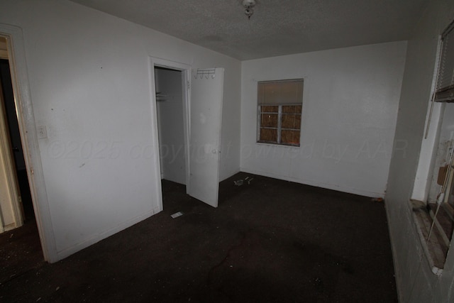 unfurnished bedroom with a closet and a textured ceiling