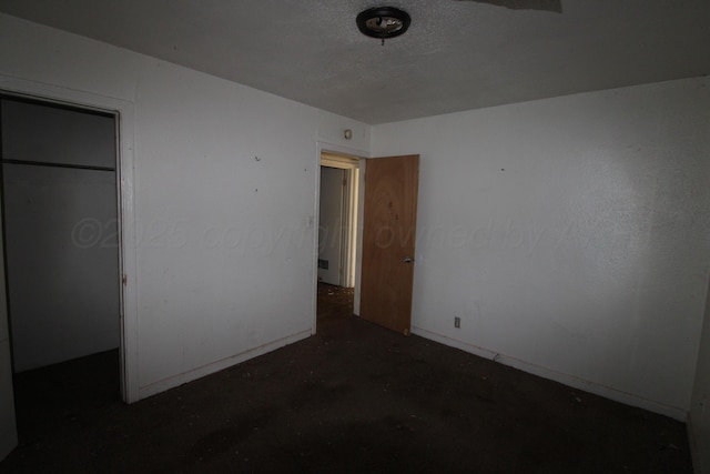 unfurnished bedroom featuring concrete flooring and a closet