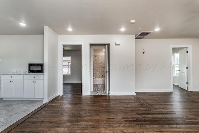 unfurnished living room with dark hardwood / wood-style flooring