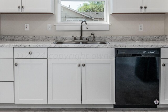 kitchen with white cabinetry, sink, and black dishwasher