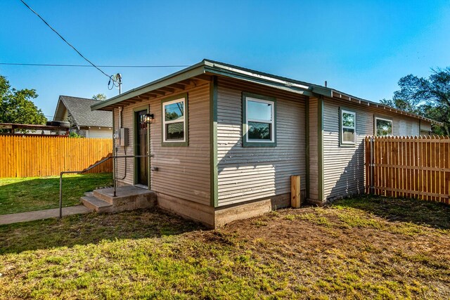 view of side of home featuring a yard