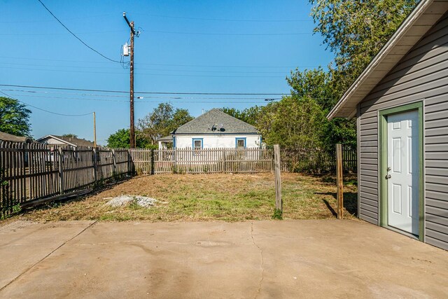 view of yard with an outbuilding and a patio area