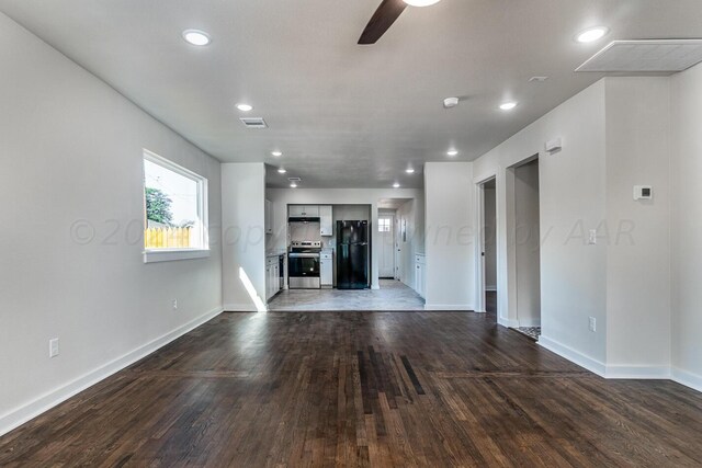 unfurnished living room featuring hardwood / wood-style flooring and ceiling fan