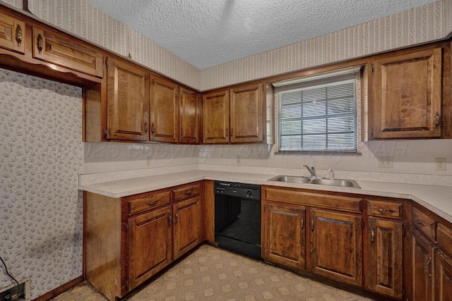 105 Pinehurst St, Borger, TX 79007 - kitchen with black dishwasher, wallpapered walls, a sink, a textured ceiling, and brown cabinets