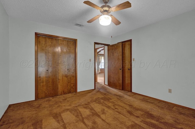 105 Pinehurst St, Borger, TX 79007 - unfurnished bedroom with carpet flooring, a textured ceiling, two closets, and a ceiling fan