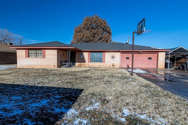 single story home with a lawn and a garage