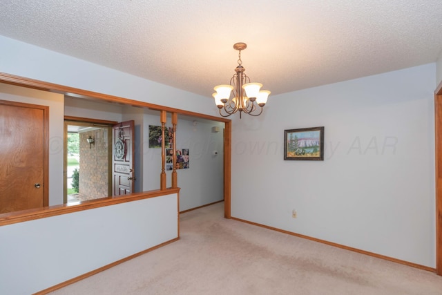 7919 Mitcham Dr, Amarillo, TX 79121 - unfurnished room with light colored carpet, a chandelier, and a textured ceiling