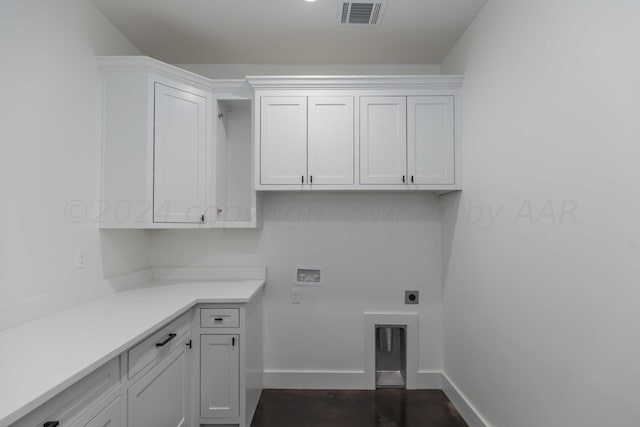 clothes washing area featuring electric dryer hookup, washer hookup, and cabinets