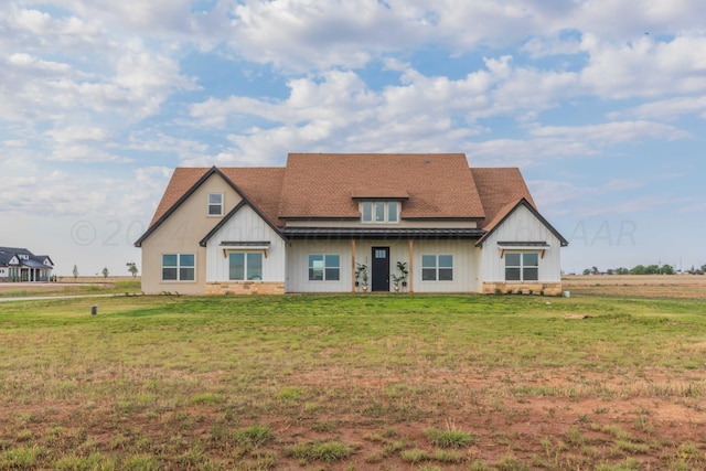 back of house with a lawn