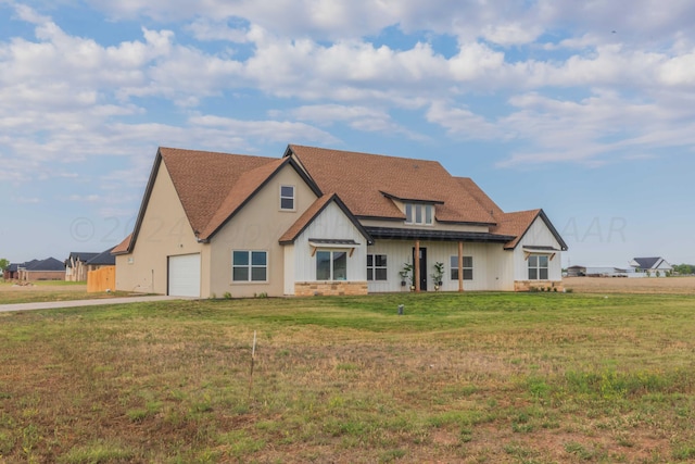 view of front of property featuring a garage and a front lawn