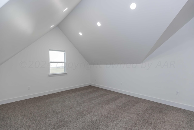 bonus room with carpet and vaulted ceiling