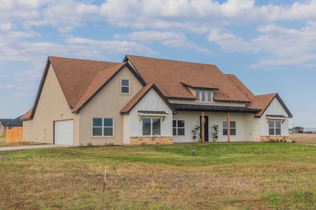back of property featuring a garage and a lawn