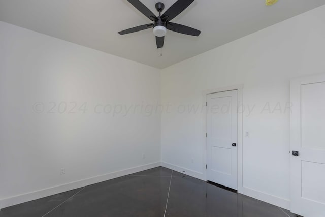 tiled empty room featuring ceiling fan