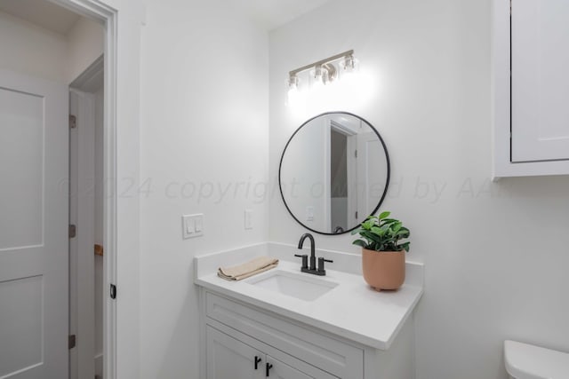 bathroom with vanity and toilet