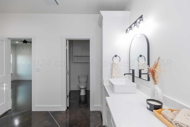 bathroom with toilet, concrete flooring, vanity, and ceiling fan