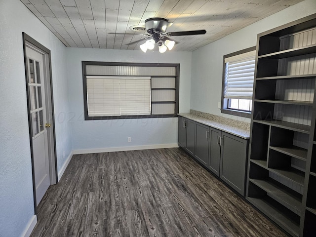 unfurnished dining area featuring ceiling fan and dark hardwood / wood-style floors